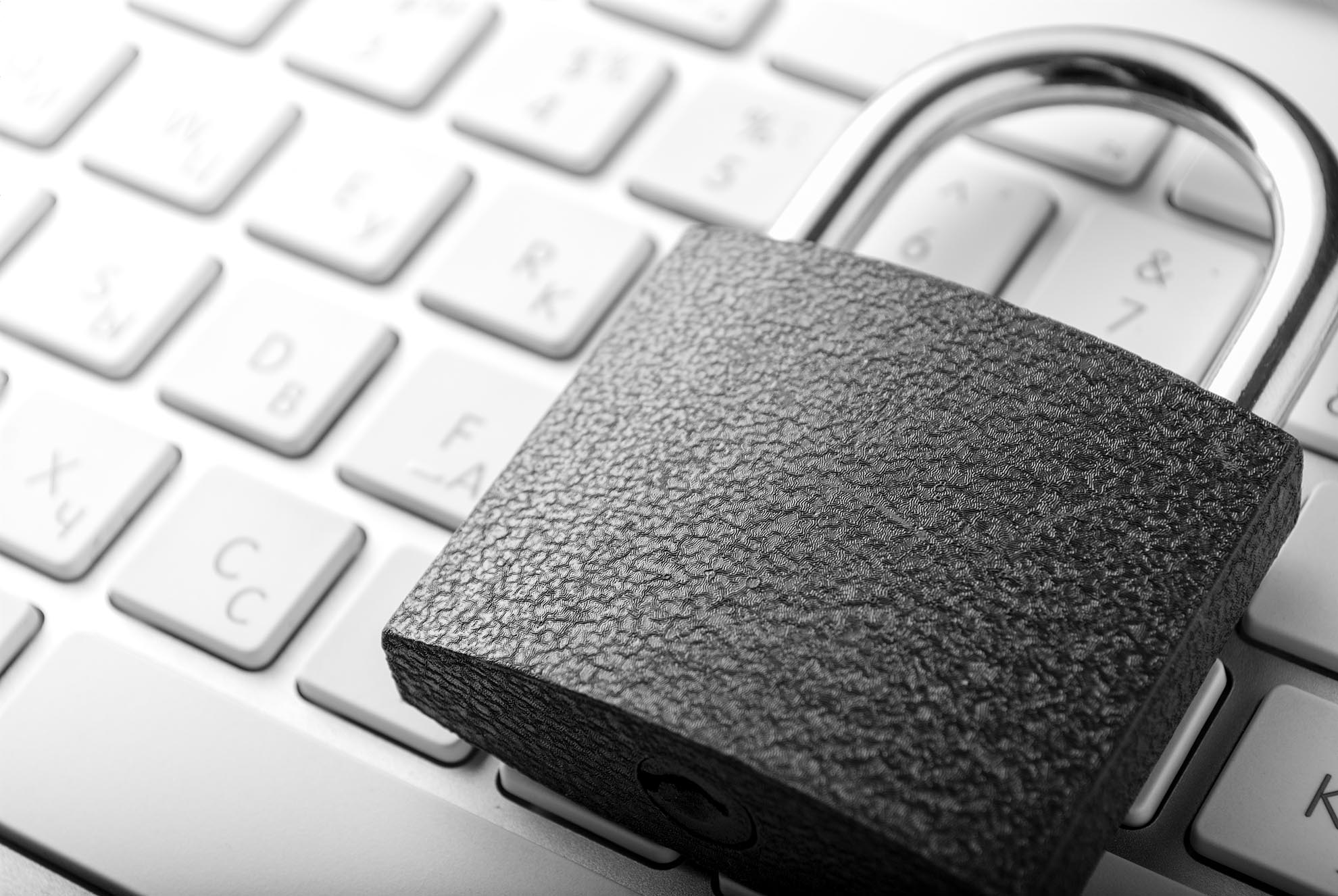 Padlock lying on the computer-keyboard